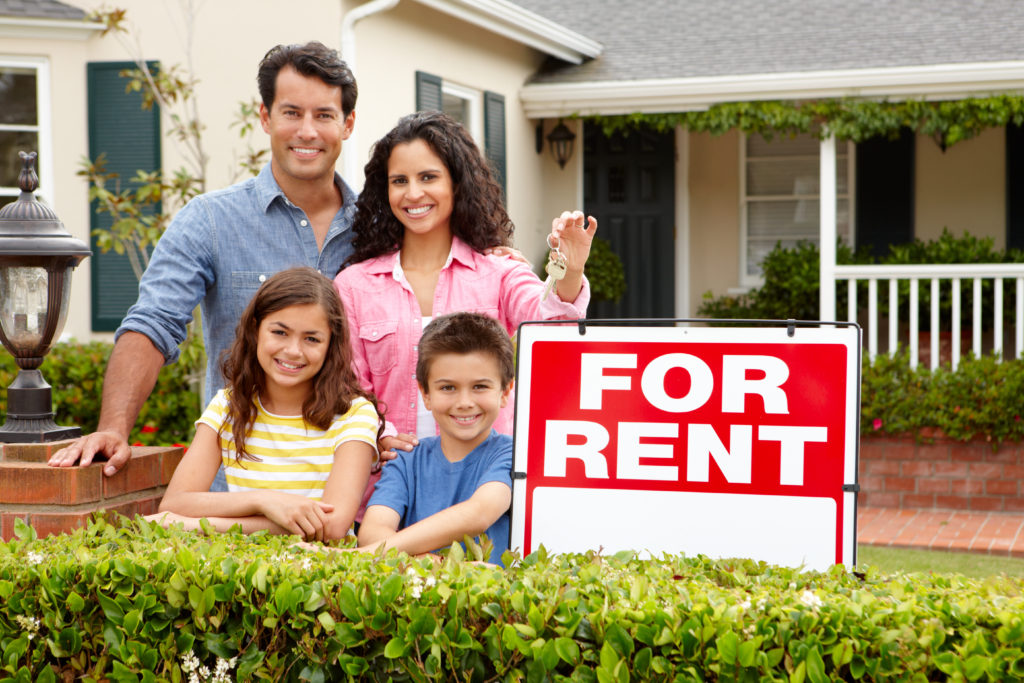 Couple with For Rent Sign